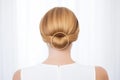 detailed golden hairpin adorning a sleek low chignon