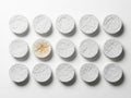 Collection of white pills with one broken pill isolated on white background Royalty Free Stock Photo