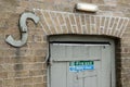 Detailed image of a fire exit door and sign seen attached to an old timber door.