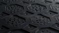 A detailed image of matte black metal featuring a slightly raised honeycomblike pattern etched into its surface Royalty Free Stock Photo