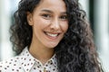 Close-up of curly hair with a polka dot patterned shirt in soft focus Royalty Free Stock Photo