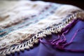 detailed image of tzitzit on the edge of a prayer shawl