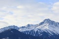 Detailed landscape of snow-covered slopes and rocky peaks of the Trans-Ili Alatau mountains on an autumn, winter morning.