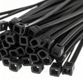 Close-up of Black Cable Ties on a White Background Royalty Free Stock Photo