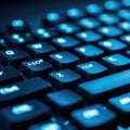Close-up view of a backlit keyboard with a blue hue, highlighting the asdf keys Royalty Free Stock Photo