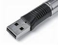 Detailed Macro Shot of a Metallic and Black USB Drive Storage on White Surface Royalty Free Stock Photo