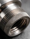 Detailed macro shot of a metallic threaded connector showcasing the textured surface and precise engineering of industrial Royalty Free Stock Photo