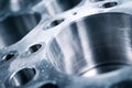 Detailed macro shot of a precision-engineered metallic engine block showcasing smooth cylindrical bore and multiple machined holes Royalty Free Stock Photo
