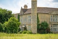 Detailed, majestic view of an unusual, Grade 2 listed, stone built manor house. Royalty Free Stock Photo