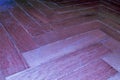 Detailed parquet floor laminate diagonally with fluorescent blue