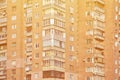 Detailed photo of multi-storey residential building with lots of balconies and windows. Hostels for poor people in Russia and Ukr