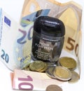Detailed photo of a small pocket antibacterial hand gel surrounded by high value Euros