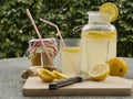 Detailed Picture of all ingredients neccesary to cook a homemade lemonade consist from water, lemon, ginger and glass of honey.