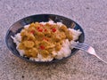 Detailed Picture of typical indian food hot lamb curry with rice and chopped chili served on the deep plate Royalty Free Stock Photo