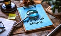 Detailed preparation for personal injury claims with notepad, pen, magnifying glass, and sticky note on a wooden desk Royalty Free Stock Photo