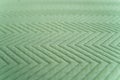 Detailed quilted green fabric with alternating zigzag geometric pattern Royalty Free Stock Photo