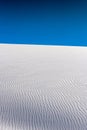 Detailed Rippling Sand Dune Sits Untouched Uner A Deep Blue Sky