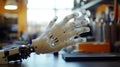A detailed robotic hand is presented on a workbench in a technology lab Royalty Free Stock Photo