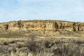 Detailed rock wall lining vast open desert landscape in rural New Mexico Royalty Free Stock Photo