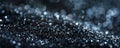 A detailed shot of black glitter with selective focus, highlighting the sharp, reflective particles Royalty Free Stock Photo