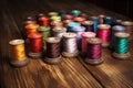 a detailed shot of colorful spools of thread on an old wooden table Royalty Free Stock Photo