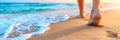 Detailed shot of feet walking on sandy beach, emphasizing connection with nature