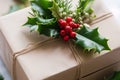 detailed shot of a gift box adorned with a sprig of holly
