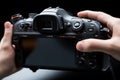 Detailed shot of a hand activating a black digital camera with a button press