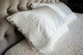 detailed shot of lacetrimmed pillow shams on a plush bed