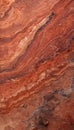 A detailed shot of Red Travertine, displaying warm red tones with natural pits and variations