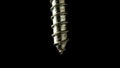 Detailed shot of a steel screw screw or metal bolt on isolated black background. Helix thread super macro closeup