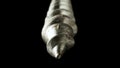 Detailed shot of a steel screw screw or metal bolt on isolated black background. Helix thread super macro closeup