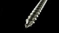 Detailed shot of a steel screw screw or metal bolt on isolated black background. Helix thread super macro closeup