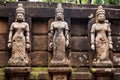 detailed shot of stone statues by a temple entrance