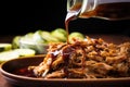 detailed shot of tangy vinegar sauce drizzling on pulled pork