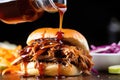 detailed shot of vinegar sauce drizzling onto pulled pork slider