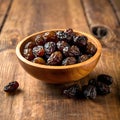 A Detailed Study of Dark Raisins in a Wooden Bowl, Featuring Textural Elements and Rich Hues Royalty Free Stock Photo