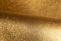 Detailed texture of glittering golden dust surface backdrop with space for text