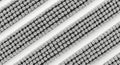 Abstract close-up of a textured surface with diagonal rows of small, round elements, creating a repetitive pattern in monochrome Royalty Free Stock Photo