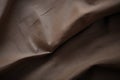 A detailed, up-close image capturing the texture and color of a brown fabric, The matte and fibrous texture of a canvas bag, AI