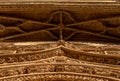 Detailed view from below of the ornaments on the cornice of the main door with bas-reliefs of fantastic animals, saints, chimeras