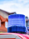 Blue rotating beacon on the roof of a red fire truck Royalty Free Stock Photo