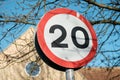 Detailed view of a British 20MPH road speed seen near a pedestrian zone. Royalty Free Stock Photo