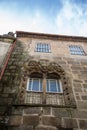 Detailed view of classic building with a gothic ornamented window, portuguese manuelino style, stone facade