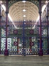 Detailed view of colourful wrought ironwork gate at Smithfield meat and poultry market in the City of London, UK.