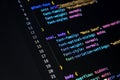 Detailed view of a dark-themed computer screen displaying various lines of programming code, showcasing a typical environment for Royalty Free Stock Photo
