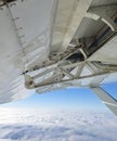 Detailed view of flaps , high-lift devices and actuators of a general aviation airplane flying at stall speed. Strut and wing of Royalty Free Stock Photo