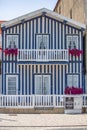 Detailed view of front facade windows and balcony with flowers of typical Costa Nova beach house Royalty Free Stock Photo