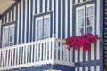 Detailed view of front facade windows and balcony with flowers of typical Costa Nova beach house Royalty Free Stock Photo