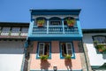 Detailed view of front facade windows and balcony with flowers of typical north portuguese house, Chaves city downtown Royalty Free Stock Photo